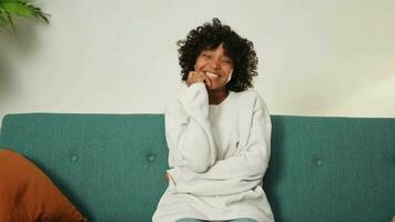 Beautiful African American girl with afro hairstyle smiling. Close up portrait of young happy black girl. Young African woman with curly hair laughing. Freedom happiness carefree happy people concept video