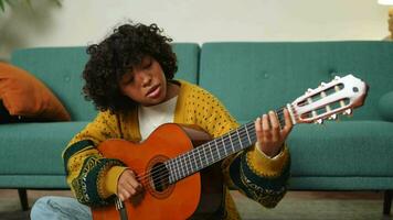 blogueiro guitarrista. feliz africano americano menina blogueiro jogando guitarra cantando música gravação vlog. social meios de comunicação influenciador mulher transmissão gravação às casa estúdio. música conteúdo O Criador transmissão video