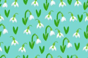 Snowdrops seamless pattern.  Repeated texture in doodle style for fabric, wrapping paper, wallpaper, tissue. Vector illustration.The first snowdrops Galanthus isolated on blue background.