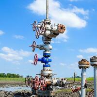 Oil well after repair in mud and puddles. photo