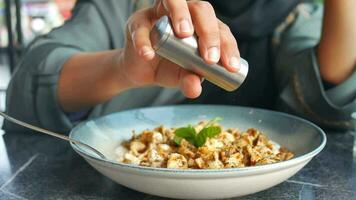 women hand putting salt in Turkish Traditional Food Ravioli Pastry named Manti video