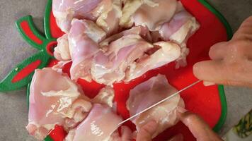 top view of cutting chicken fillet on a chopping board video