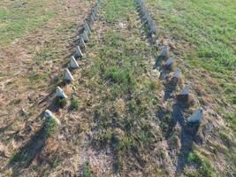 The ruins of the old farm. Cones column base of the wall. Abandoned and ruined buildings photo