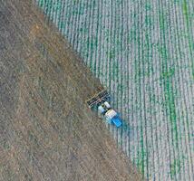 Top view of the tractor that plows the field. disking the soil. Soil cultivation after harvest photo