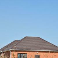 Detached house with a roof made of steel sheets. photo