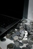 Coin Indonesian rupiah and laptop photo