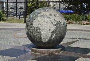 Granite bowl engraved maps of the world. The symbol of peace and photo