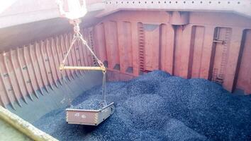 The cargo compartment of the ship, filled with coal. Loading of anthracite. Transportation of coal. photo