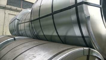 Steel sheets rolled up into rolls. Export Steel. Packing of steel for transportation photo