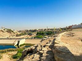 A beautiful daytime view of Wadi Namar Dam in riyadh , Saudi Arabia. The water of the dam and the surrounding hills are presenting a beautiful scene in the sunlight. photo