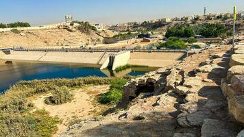 A beautiful daytime view of Wadi Namar Dam in riyadh , Saudi Arabia. The water of the dam and the surrounding hills are presenting a beautiful scene in the sunlight. photo