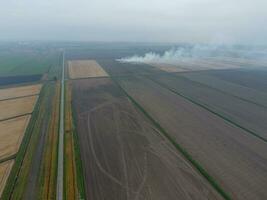Burning straw in the fields after harvesting wheat crop photo