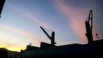 Port landscape at sunset. Port cranes. photo