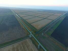 Crossroads paved roads through the fields. View from above photo