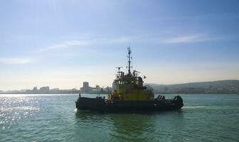 A service small boat in the harbor harbor. Tsemesskaya bay. Industrial port photo