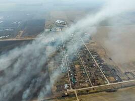 Top view of the small village. Smoke from the burning of straw i photo