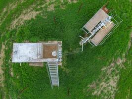 Equipment of an oil well. A tank with methanol near the oil well. Shutoff valves and service equipment photo