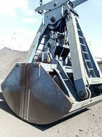 Clamshell bucket in the cargo port. Bucket for loading coal photo