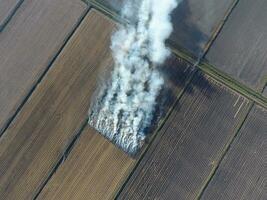 Burning straw in the fields after harvesting wheat crop photo