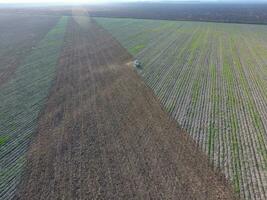 Top view of the tractor that plows the field. disking the soil. Soil cultivation after harvest photo