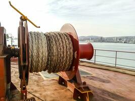 Mechanisms of tension control ropes. Winches. Equipment on the deck of a cargo ship or port photo