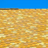 Roof from multi-colored bituminous shingles. Patterned bitumen shingles. photo