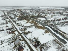 Winter view from the bird's eye view of the village. The streets are covered with snow photo