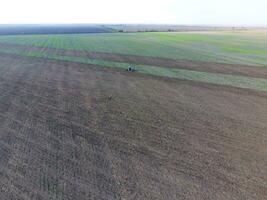Top view of the tractor that plows the field. disking the soil. Soil cultivation after harvest photo