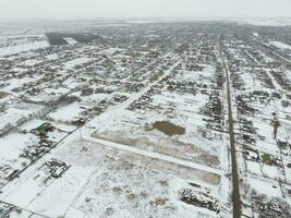 Winter view from the bird's eye view of the village. The streets are covered with snow photo