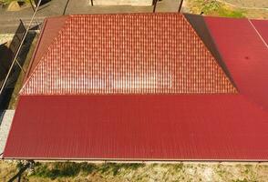 A house with a canopy over the courtyard. Roof from corrugated metal profile. Metal tiles. photo