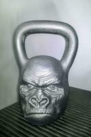 Sports Equipment. Creative weights. Weight-lifting weights in the performance of orcs. Spiteful faces photo