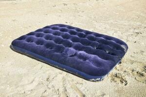 Blue inflatable mattress swimming in the pond photo