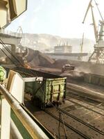 Cargo industrial port, port cranes. Loading of anthracite. Transportation of coal. Heap of coal photo