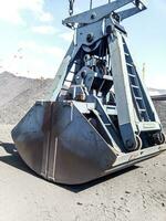 Clamshell bucket in the cargo port. Bucket for loading coal photo