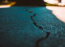 Closeup of the cracks in asphalt photo