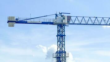 View of blue tower crane which the structures are made of steel photo