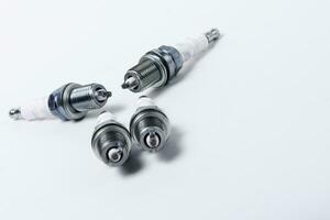 Car spark plugs on white background. Car spare parts photo