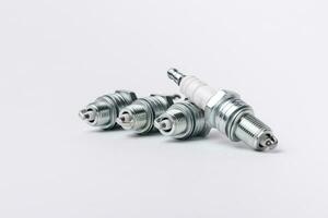 Car spark plugs on white background. Car spare parts. photo