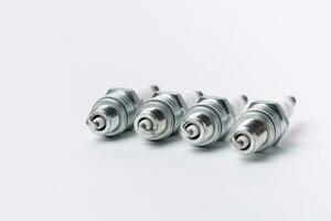 Car spark plugs on white background. Car spare parts. photo