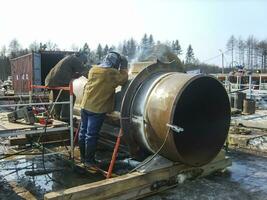 Safety at work. Welding and installation of the pipeline. Indust photo