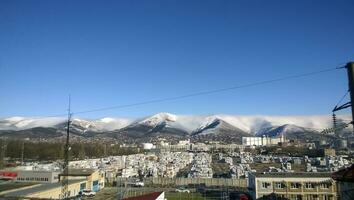 Terrestrial warehouses and storage facilities near the seaport. A view of the mountain peaks photo