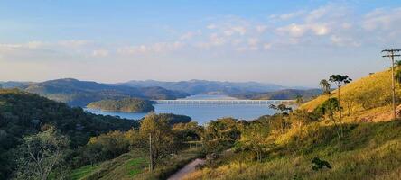 Serene lake in the mountains of Brazil lush and tranquil setting, natural beauty that enchants. Highlight your creativity with this stunning view photo