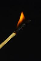 burning match in dark photo