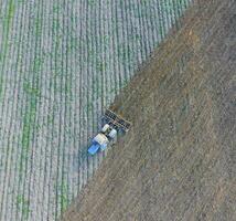 Top view of the tractor that plows the field. disking the soil. photo