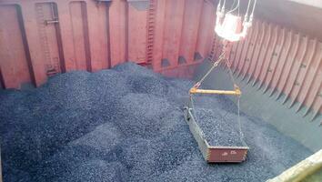 The cargo compartment of the ship, filled with coal. Loading of photo