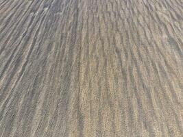 Top view of a plowed field. Background texture of the surface of the plowed field. Shooting with quadrocopters photo