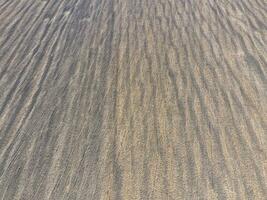 Top view of a plowed field. Background texture of the surface of the plowed field. Shooting with quadrocopters photo