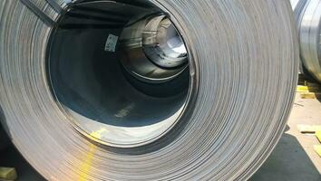 Steel sheets rolled up into rolls. Export Steel. Packing of steel for transportation photo