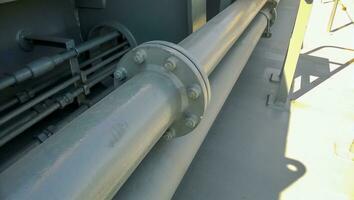 Flanged connection on a gray pipe. Pipes on the deck of the ship photo