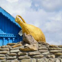 Gilded pitcher on masonry photo